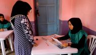 This photo taken on April 14, 2018 shows an Afghan employee of the Independent Election Commission (IEC) registering a resident at a voter registration center for the upcoming parliamentary and district council elections in Kabul. AFP / HOSHANG HASHIMI