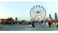 Visitors enjoy various rides at the Entertainment World Village located behind Diplomatic Club, yesterday.  Pic: Qassim Rahmatullah / The Peninsula 