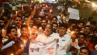 File photo of Indian Congress workers participate in a candle light procession as they shout slogans against Indian Prime Minister Narendra Modi during a protest against rape incidents, in Allahabad, April 13, 2018. / AFP / SANJAY KANOJIA 