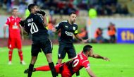 Al Sadd’s Xavier Hernandez (centre) and Salem Ali Al-Hajri (left) react as Persepolis’ Ali Alipour falls to the ground during the AFC Champions League match  at the Azadi Stadium in Tehran on Monday.