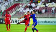 Al Duhail’s forward Youssef El Arabi (left) vies for the ball with Al Wahda’s Rim Chang Woo during yesterday’s match.