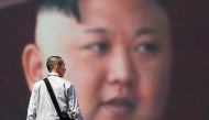 A man walks past a street monitor showing North Korea's leader Kim Jong Un in a news report about North Korea's announcement, in Tokyo, Japan, April 21, 2018. REUTERS/Toru Hanai