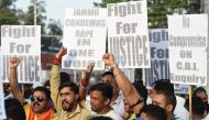 Indian supporters of Bharatiya Janata Party (BJP) leader Chaudhary Lal Singh, who resigned from the state cabinet over the Kathua rape and murder case of an eight-year-old girl, hold placards during a rally in support of a new probe led by the federal Cen
