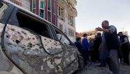 Afghan men inspect the site of a suicide bomb blast in Kabul, Afghanistan April 22, 2018. REUTERS/Omar Sobhani