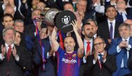 Barcelona's Spanish midfielder Andres Iniesta (C) holds the trophy after the Spanish Copa del Rey (King's Cup) final football match Sevilla FC against FC Barcelona at the Wanda Metropolitano stadium in Madrid on April 21, 2018. Barcelona won 5-0. / AFP / 