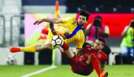 Al Duhail's Murad Naji vies for the ball posession against an Al Gharafa player during yesterday's Qatar Cup semi-final.
