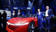Herbert Diess, Volkswagen's new CEO, and another company leader pose for a photo next to a Volkswagen I.D. concept car at a media event ahead of the Beijing Auto Show in Beijing, China April 24, 2018. Reuters/Jason Lee