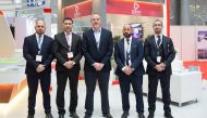 The officials of Ezdan Holding Group pose in front of it’s pavilion at the Citysacpe Qatar 2018  venue.
