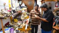 Indian bat maker Aslam Chaudhry inspecting a cricket bat at his workshop in Mumbai. (AFP / Indranil Mukherjee)
