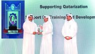 In the presence of H E Dr. Mohammed bin Saleh Al Sada (right), Minister of Energy and Industry; Saad Sherida Al Kaabi (left), President and CEO, Qatar Petroleum, hands over the award to  Abdullah Al Sulaiti, CEO of Nakilat.
