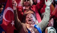 A supporter of the Turkish President cheers as she waits for the start of his speech in Istanbul, on May 6, 2018. AFP / Bulent Kilic