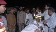 In this handout photograph released by the Press Information Department (PID) Punjab on May 6, 2018, injured Pakistan's Interior Minister Ahsan Iqbal (C) is evacuated from a helicopter on their arrival in Lahore. 