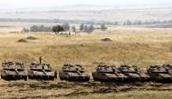 Israeli Merkava tanks and soldiers are seen in a deployment area near the Syrian border in the Israel-annexed Golan Heights on May 10, 2018. AFP / Menahem KAHANA
