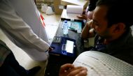 An Iraqi man casts his vote at a polling station during the parliamentary election in the Sadr city district of Baghdad, Iraq May 12, 2018. REUTERS/Thaier al-Sudani