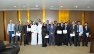 Dr. R Seetharaman, CEO of Doha Bank, with other officials and employees who have won the awards, during the event.