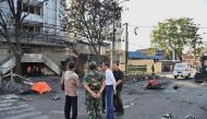 Handout photo released by the Presidential Palace shows Indonesia's President Joko Widodo (2nd R) visiting the scene of a suicide attack outside the Central Pantekosta church in Surabaya, May 13, 2018 . AFP PHOTO / Presidential Palace