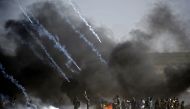 Tear gas is fired at protestors during clashes with Israeli forces near the border between the Gaza strip and Israel, east of Gaza City on May 14, 2018, following the the controversial move to Jerusalem of the United States embassy. AFP / Thomas Coex