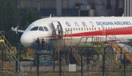 Workers inspect a Sichuan Airlines aircraft that made an emergency landing after a windshield on the cockpit broke off, at an airport in Chengdu, Sichuan province, China May 14, 2018. REUTERS/Stringer