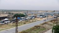 The fifth convoy carrying civilians depart from Homs, Syria due to Assad regime's intense assaults and blockage as part of the compulsory evacuation to reach Idlib and western Aleppo on May 13, 2018.Mohammad Alammory - Anadolu 
