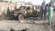 Residents look at an Army vehicle which was damaged during battle between Afghan security forces and Taliban in Farah province, Afghanistan May 16, 2018. REUTERS/Stringer