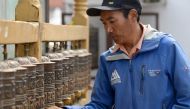 (FILES) In this photograph taken on March 28, 2018, Nepali mountaineer Kami Rita Sherpa spins prayer wheels at Boudhanath Stupa, where he has a rented room, on the outskirts of Kathmandu. XGTY / AFP / PRAKASH MATHEMA / XGTY