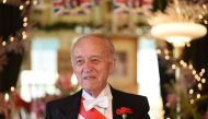 Owner Edmund Fry smiles during an interview with AFP at The Rose Tree Cottage which serves traditional English afternoon tea, in Pasadena, north of Los Angeles, California, May 15, 2018, where Meghan Markle has been a guest, Fry offering her tips on how t