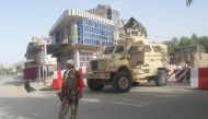 An Afghan security force personnel stands guard at the entrance gate of the government compound of Farah province, western Afghanistan May 15, 2018. REUTERS/Stringer