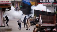 Demonstrators hurl stones towards Indian police, during a protest against the recent killings of Palestinian protesters on the Gaza-Israel border and the U.S. embassy move to Jerusalem, in Srinagar, May 18, 2018. REUTERS/Danish Ismail