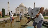 Labourers clean the fountain in the historic Taj Mahal premises in Agra, India, May 19, 2018. Reuters/Saumya Khandelwal
