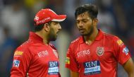 Kings XI Punjab cricketer Yuvraj Singh (L) talks with teammate Ankit Rajpoot after he was hit for runs during the 2018 Indian Premier League (IPL) Twenty20 cricket match between Mumbai Indians and Kings XI Punjab at the Wankhede Stadium in Mumbai on May 1