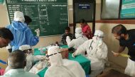 Medical personnel wearing protective suits check patients at the Medical College hospital in Kozhikode on May 21, 2018. (AFP) 