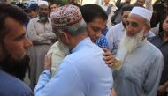Abdul Aziz (2R), father of slain Pakistani exchange student Sabika Sheikh, who was killed during a school shooting in Texas, meets with people during his daughter's funeral in Karachi on May 23, 2018. AFP / IMRAN ALI