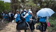 Participants take part in a beach clean-up on Hong Kong's outlying Lamma island on May 27, 2018. AFP / Anthony Wallace