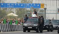 Indian Prime Minister Narendra Modi waves to supporters during a road-show event in New Delhi on May 27, 2018. / AFP / Sajjad HUSSAIN
