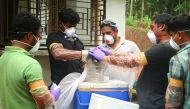 Animal Husbandry department and Forest officials deposit a bat into a container after catching it inside a well at Changaroth in Kozhikode in the Indian state of Kerala on May 21, 2018. (AFP) 
