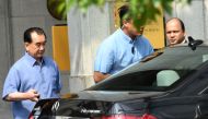 Kim Chang Son (L), North Korean leader Kim Jong Un's de facto chief of staff, prepares to get into a car as he leaves a hotel in Singapore on May 29, 2018. / AFP / Roslan RAHMAN
