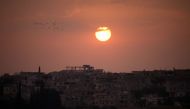A general view shows the sun setting over a rebel-held area in the southern Syrian city of Daraa on May 28, 2018. / AFP / Mohamad ABAZEED
