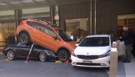 Hotel staff and guests can be seen near a car accident outside the main entrance of a hotel located in the central business district (CBD) of Sydney, Australia, May 31, 2018. REUTERS/Paul Tait