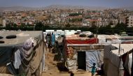 Syrian children play in a makeshift refugee camp on the outskirts of the town of Zahle in Bekaa Valley,  Lebanon,  on June 20, 2016.  AFP / Patrick Baz