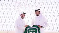 SC Secretary-General, Hassan Al Thawadi, presenting Mohammed Saadon Al Kuwari with an SC shirt to officially welcome him into the ambassador programme.
