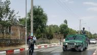 Afghan policemen stand guard near the site of a suicide attack at the gates of Kabul's Polytechnic University in Kabul on June 4, 2018. AFP / Ahmad Zafar 