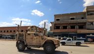 Vehicles from the US-led coalition battling the Islamic State group patrol the town of Rmelane in Syria's Hasakeh province on June 5, 2018.  AFP / Delil souleiman
