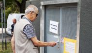 A community member tries to open the door of the 