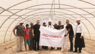 The staff of Mövenpick Hotel West Bay Doha poses after planting herbs and organic vegetables as part of its World Environment Day campaign. 