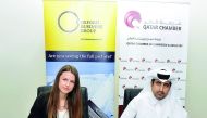 Saleh bin Hamad Al Sharqi (right), Director-General of Qatar Chamber, and Izabela Kruk, Country Director of Oxford Business Group, signing the MoU.