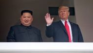 U.S. President Donald Trump waves next to North Korean leader Kim Jong Un at the Capella Hotel on Sentosa island in Singapore June 12, 2018. Kevin Lim/The Straits Times via REUTERS