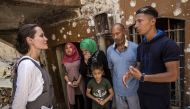 US actress and the UN refugee agency UNHCR (United Nations High Commissioner for Refugees) Special Envoy Angelina Jolie (L) chats with residents on needs of people and reconstruction works during her visit in Iraq’s northern city of Mosul on June 16, 2018