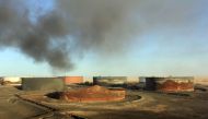 A file photo taken on January 08, 2016 shows smoke billowing from a petroleum storage tank after a fire was extinguished at Al-Sidra oil terminal, near Ras Lanuf in the so-called 