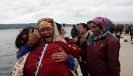 Relatives cry while waiting for news on missing family members who were on a ferry that sank yesterday in Lake Toba, at Tigaras Port, Simalungun, North Sumatra, Indonesia June 19, 2018. REUTERS/Albert Damanik