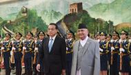 Nepal's Prime Minister K.P. Sharma Oli (center R) reviews a military honour guard with Chinese Premier Li Keqiang during a welcome ceremony at the Great Hall of the People in Beijing on June 21, 2018. AFP / Greg Baker